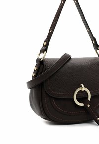 Donkerbruine leren schoudertas met een gestructureerde afwerking, voorzien van contrasterende stiksels, een ronde hardware-accent en een verstelbare schouderband.