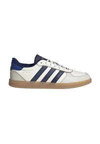 White sneaker with navy accents, three navy stripes, textured leather upper, and a gum rubber sole. Features round laces and perforated detailing.