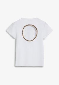 White short-sleeve t-shirt featuring a round cutout on the back, embellished with a textured brown design around the edges.