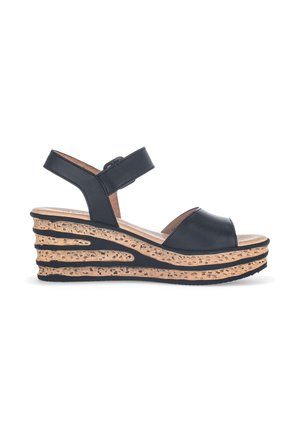 Sandale compensée en cuir noir avec bride de cheville et semelle plateforme à motif liège, design à bout ouvert, vue de côté sur fond blanc.