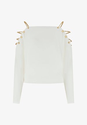 Weißes Langarmoberteil mit goldenen Ketten- und Knopfdetails entlang der Schultern und Oberarme, mit einem quadratischen Ausschnitt.