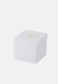 White square box with textured finish, features gold triangular logo with "GUESS?" text on the lid, designed for jewelry or accessories.