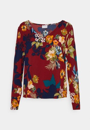 Long-sleeve top in maroon fabric featuring a floral pattern with shades of orange, yellow, green, and blue. V-neck design.