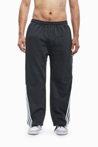 Black sweatpants with white stripe accents on the sides, featuring an elastic waistband and a relaxed fit. Made of soft, comfortable material.