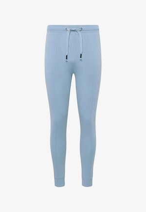 Ljusblå joggerbyxor i mjukt tyg, med elastisk midja och snörning, sidofickor och avsmalnande ben.