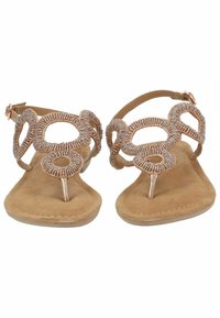 Sandali piatti con perline e soletta in suede color tan, caratterizzati da un design decorativo in metallo e una cinghia alla caviglia per una vestibilità sicura.
