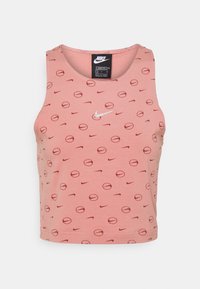 Rosafärgad ärmlös crop top med rund halsringning, som har ett repetitivt mönster av mörkröda cirklar och Nike-logotyper, tillverkad av mjukt tyg.
