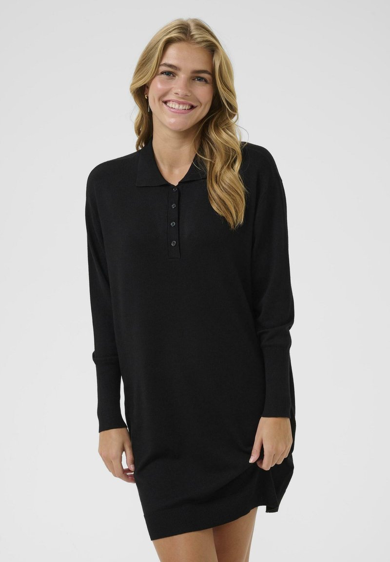 Black, long-sleeve polo dress in soft fabric featuring a collared neck and five-button placket, with a relaxed fit and side slits.
