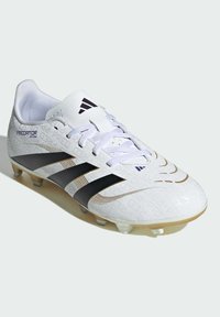 White soccer cleat with textured upper, three black stripes, gold accents, and a lace closure. Features molded studs for traction.