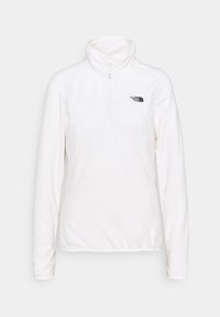 Biały polarowy sweter z kołnierzem stójkowym, zamek błyskawiczny do połowy z przodu oraz logo na lewej piersi. Miękka faktura i długie rękawy.