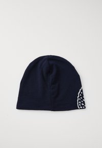 Căciulă tricotată de culoare albastră închisă, cu un finisaj texturat. Prezintă un model cu buline albe pe o parte. Material neted și moale, cu vârful rotunjit.
