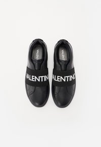 Sneakers neri con suola in gomma, dotati di una larga banda elastica nera con l'etichetta "VALENTINO". Texture in pelle liscia con design a collarino basso.