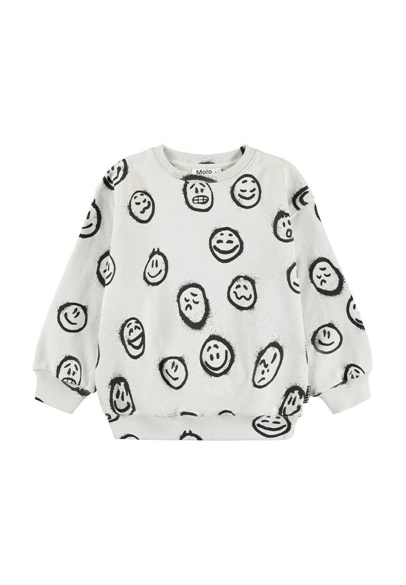 Vit sweatshirt med mönster av svarta leende och ledsna ansikten. Den har långa ärmar, rund halsringning och ribbade muddarna och nederkant.