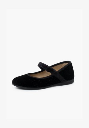 Zapato tipo Mary Jane de terciopelo negro con punta redonda, correa ajustable y acentos de brillantina colorida en la parte superior. Suela plana, forro interior suave.