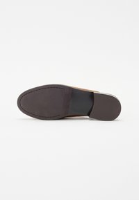 Brown leather shoe sole with a rounded shape, smooth texture, and a dark brown rubber outsole. Stitching detail along the edge.