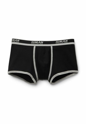 Boxer da uomo neri in cotone con cintura elastica grigia con la scritta "Intimissimi Uomo". Materiale morbido e dettagli di cucitura a contrasto.