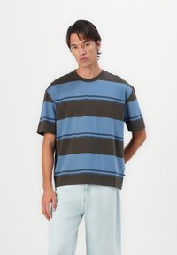 Striped T-shirt featuring blue and brown colors, short sleeves, a crew neckline, and a loose fit, made from soft cotton material.