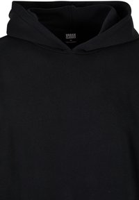 Felpa nera con cappuccio realizzata in morbido cotone. Caratterizzata da un cappuccio con cordoncino, una vestibilità rilassata e un'etichetta interna con il marchio "URBAN CLASSICS".