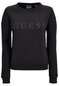 Felpa nera in misto cotone. Presenta un colletto e polsini a costine, con il logo "GUESS" tono su tono impresso sulla parte anteriore.