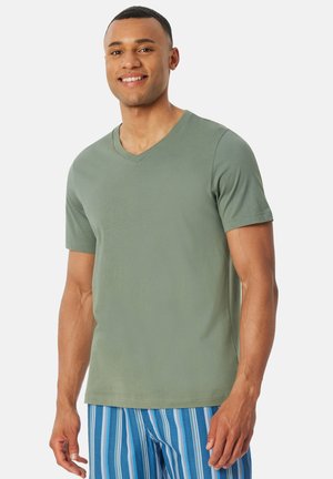 V-neck short-sleeve T-shirt in muted green cotton fabric, featuring a relaxed fit and smooth texture; paired with blue striped shorts.