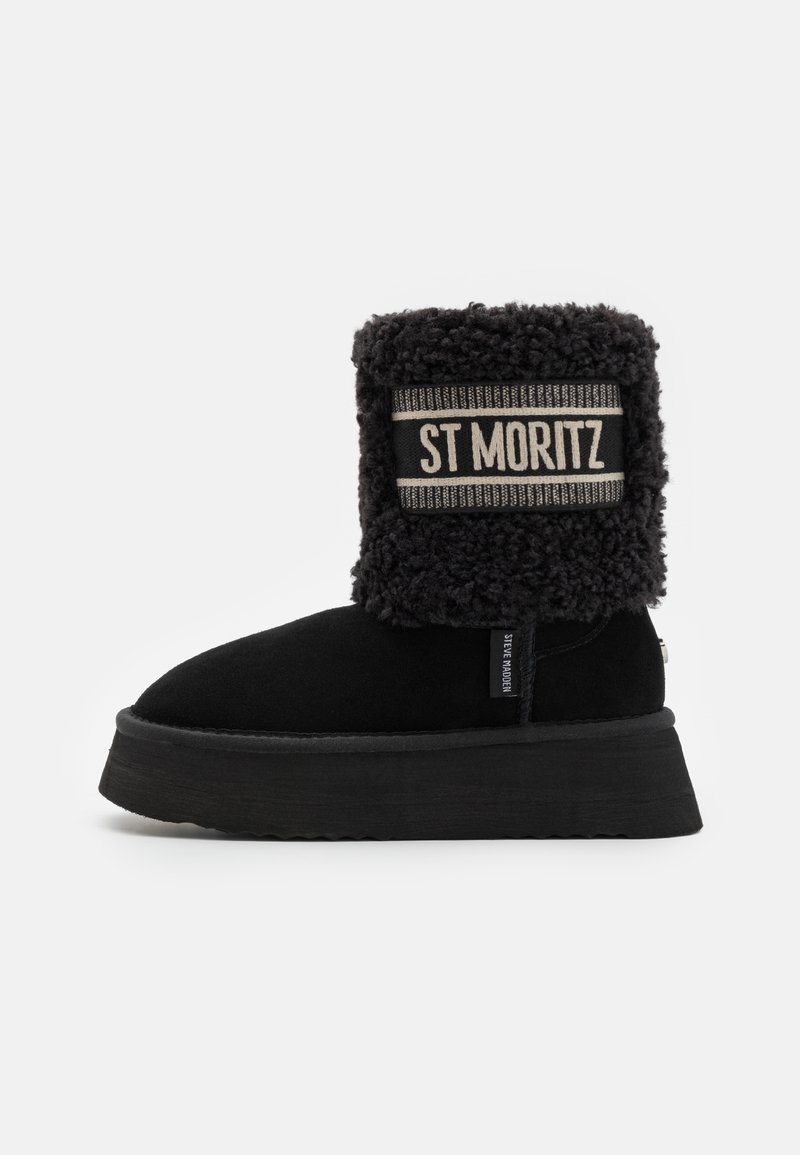 Botim preto com parte superior em pelos sintéticos texturizados, apresentando uma sola de plataforma espessa e uma faixa de logotipo marcada "ST MORITZ" na parte superior.