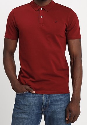 Bordeaux polo skjorte med korte ærmer, to knapper ved kraven og et lille logo på brystet. Glat stof, tætsiddende design.