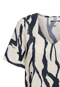 Short-sleeve V-neck shirt made of lightweight fabric with a cream base and bold, dark blue abstract patterns. Textured finish.