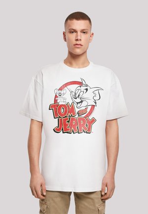 White cotton T-shirt featuring a graphic of Tom and Jerry. Design includes bold red and black text with cartoon images of a cat and mouse.