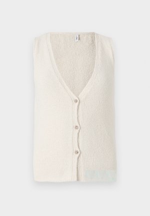 Helles cremefarbenes ärmelloses Top mit V-Ausschnitt, ausgestattet mit vier Knöpfen vorne und einem strukturierten Stoffmuster.