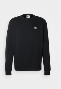 Sudadera negra de Nike con cuello redondo, mangas largas y un pequeño logo blanco en el pecho. Fabricada con un tejido suave y texturizado.