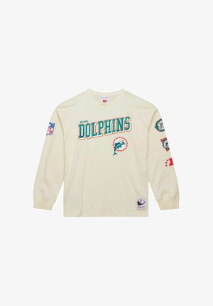 Long-sleeve cream shirt featuring "Miami Dolphins" text, dolphin graphic, NFL patch on the left sleeve, and various logo accents on the right sleeve.