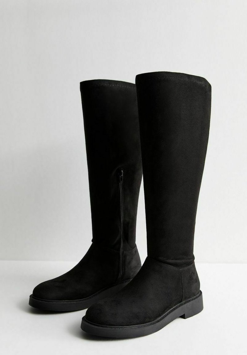 Schwarze Wildleder-Stiefel bis zum Knie mit glatter Oberfläche, ausgestattet mit einem seitlichen Reißverschluss und einer flachen Gummisohle. Einfaches, elegantes Design ohne Muster.