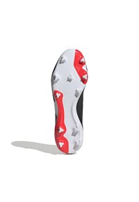 Suela de bota de fútbol en blanco y negro con detalles rojos; cuenta con tapones moldeados para tracción, superficie texturizada y el logo en relieve "PREDATOR".