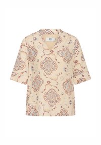 Blusa corta a maniche corte color crema con scollatura a V. Presenta ornate fantasie geometriche rosse e blu e una vestibilità rilassata.