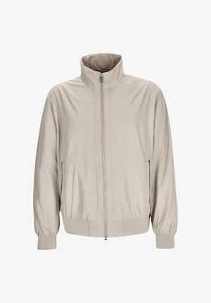 Hellbeige Jacke mit Reißverschluss, hohem Kragen, elastischen Bündchen und zwei seitlichen Reißverschlusstaschen, auf weißem Hintergrund gezeigt.