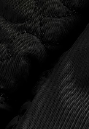 Black quilted fabric with a smooth texture, featuring prominent stitching patterns and a durable appearance. Soft and slightly padded.