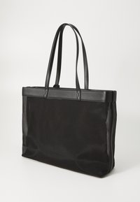 Black tote bag with a sleek, rectangular shape. Made of durable material, featuring leather accents and two long, sturdy handles.
