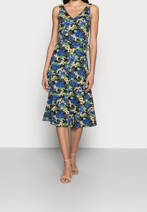 Sleeveless V-neck knee-length dress with blue and yellow floral pattern, fitted waist tie, paired with beige ankle-strap sandals.