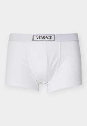 White men's boxer briefs made of soft fabric, featuring a wide elastic waistband with a black "VERSACE" logo tag. Simple design, no patterns.