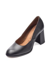 Scarpa con tacco alto in pelle nera, con punta arrotondata, tacco spesso e superficie liscia. L'interno presenta una soletta color beige chiaro.