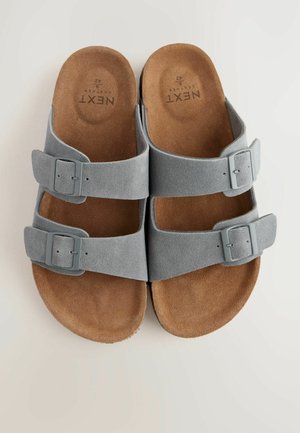 Grijze nubuck sandalen met twee verstelbare banden en een kurken voetbed. Voorzien van zilveren gespen en een gladde, matte textuur.