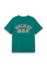 Maglietta verde a maniche corte con grande testo "GRIMEY" e caratteri stilizzati stampati in rosa e bianco sul retro. Vestibilità classica.