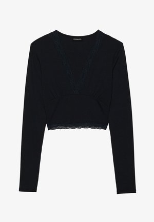 Black ribbed long-sleeve top with a deep V-neck and lace accents. Cropped length and textured fabric, featuring fitted body and lace trim at the hem.