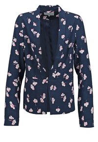 Blazer bleu marine à motif floral rose et blanc, manches longues, devant ouvert avec une coupe ajustée.