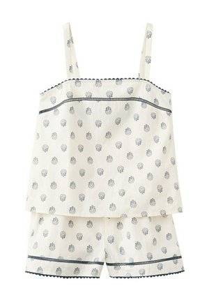 Ensemble de pyjama sans manches crème avec imprimé floral bleu marine, bordure festonnée, et short assorti avec des bandes horizontales décoratives.