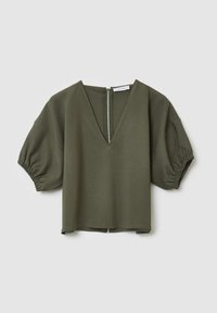 Top corto a maniche corte verde oliva con scollatura a V e chiusura con zip sul retro. Presenta maniche a sbuffo e una vestibilità comoda. Tessuto di cotone morbido.
