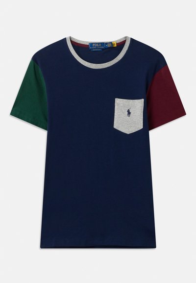Camiseta de color azul marino con mangas cortas en verde y burdeos. Presenta un bolsillo gris con un logo, cuello redondo con ribete gris y una textura suave.