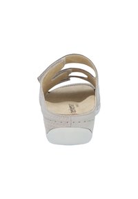 Light gray sandal with a woven texture and cut-out design on the upper. Soft beige insole with a white rubber outsole.