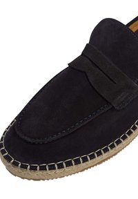 Mocassini in suede di un blu scuro con una texture morbida, dotati di un accento a fiocco e bordatura in juta intrecciata beige sulla suola. Design a punta arrotondata.