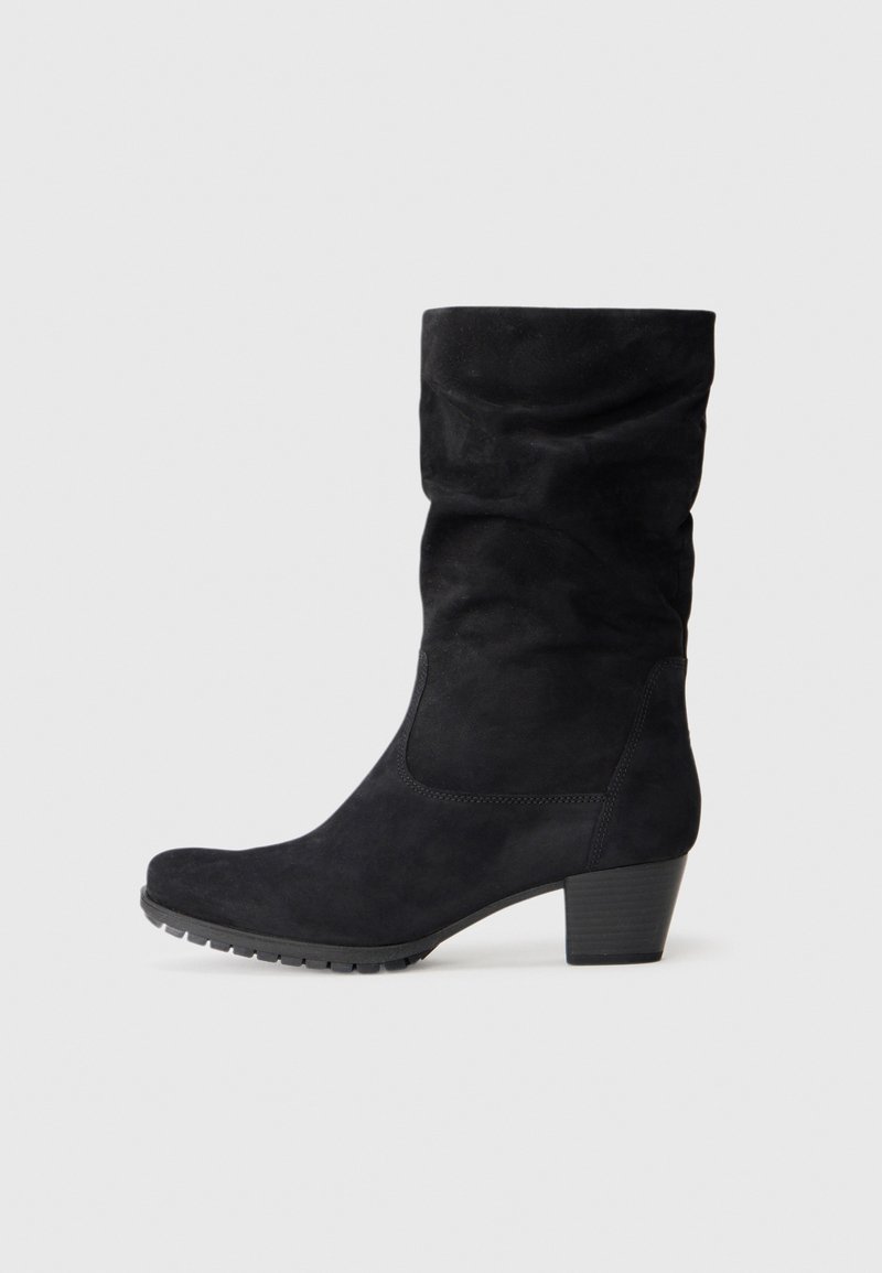 Black suede knee-high boots with a slouchy design, rounded toe, textured surface, and a low block heel. Features a rubber sole for traction.